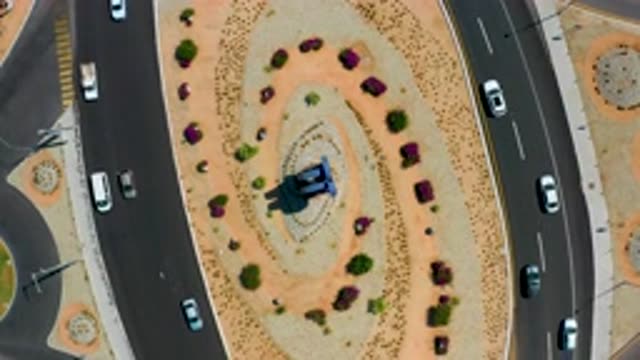 LOS CABOS MEXICO-2020: Cars Driving Around An Oval With Sand And Bushes In The