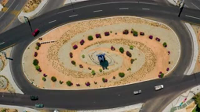 LOS CABOS MEXICO-2020: Cars Driving In A Tragic Circle With Shrubs And Trees In