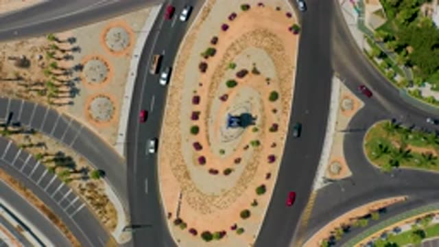 LOS CABOS MEXICO-2020: Automobiles Merging On And Off Of A Decoratively Landscaped Roundabout