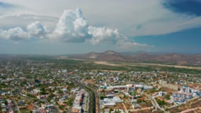 LOS CABOS MEXICO-2020: Aerial View Of A Small Desert City With Clouds Above