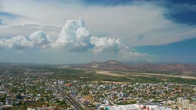 LOS CABOS MEXICO-2020: Partially Cloudy Daytime Aerial View of City and Mountains