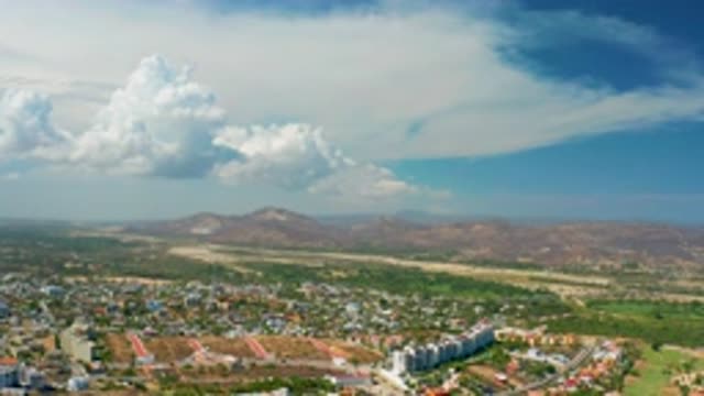 LOS CABOS MEXICO-2020: Sunny And Cloudy View Of A City Near A Mountainous Desert