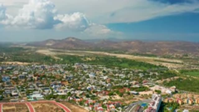 LOS CABOS MEXICO-2020: A Blue Sky Day Overseeing A Small Town With Mountains