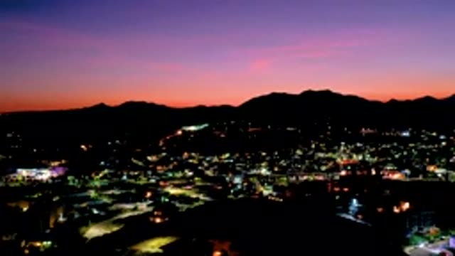 LOS CABOS MEXICO-2020: Time Lapse Sunset And City Lights Over Large Busy City