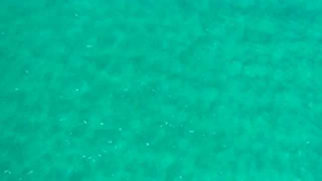 LOS CABOS MEXICO-2020: Light Blue Waves Rippling In Shallow Empty Waters And