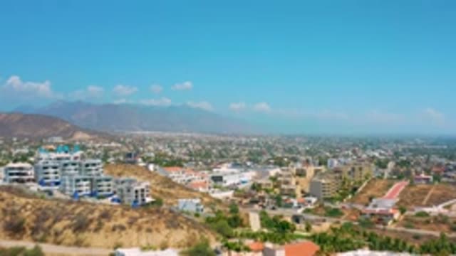 LOS CABOS MEXICO-2020: An Aerial View Of A City With High Rise Buildings And Mountains