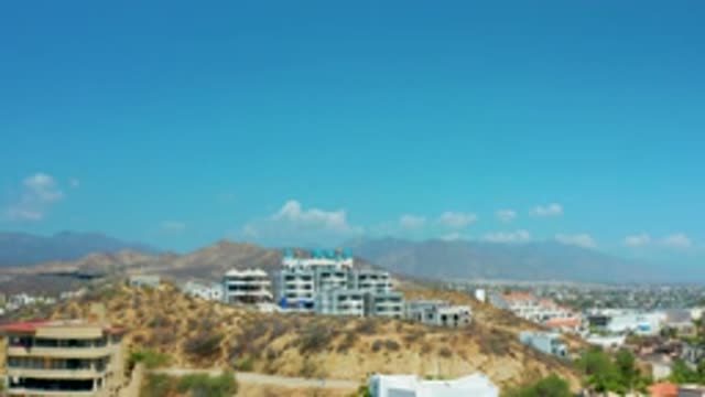 LOS CABOS MEXICO-2020: Aerial View Of Buildings On A Hill With A Clear Blue Sky