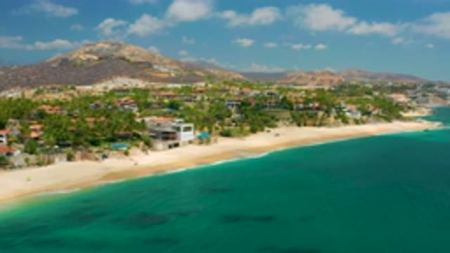 PALMILLA BEACH CABO MEXICO-2020: Scenic Beach with Ocean, Palm Trees, and Mountains