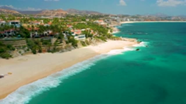 PALMILLA BEACH CABO MEXICO-2020: Beach Town Building Lining Shore Waves Crashing