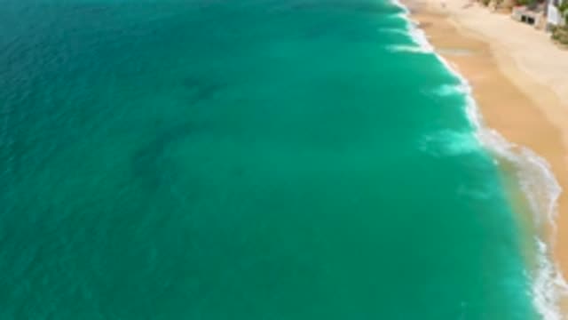 PALMILLA BEACH CABO MEXICO-2020: Blue Greenish Ocean Water Waves Onto A Beach