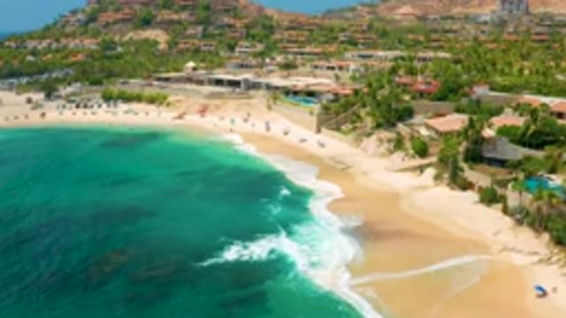 PALMILLA BEACH CABO MEXICO-2020: Dark Turquoise Waves Break Against Busy Tourist Beach