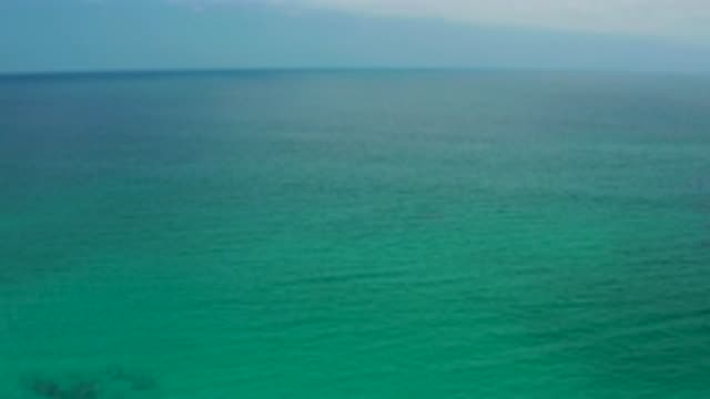 PALMILLA BEACH CABO MEXICO-2020: Beautiful Shot Of A Green Ocean That Pans Up To