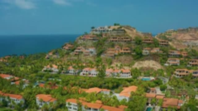 PALMILLA BEACH CABO MEXICO-2020: Tropical Town With Hill And Camera Panning Up
