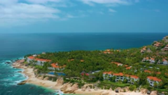 PALMILLA BEACH CABO MEXICO-2020: Camera Zooms Away From A Peninsula Dotted With