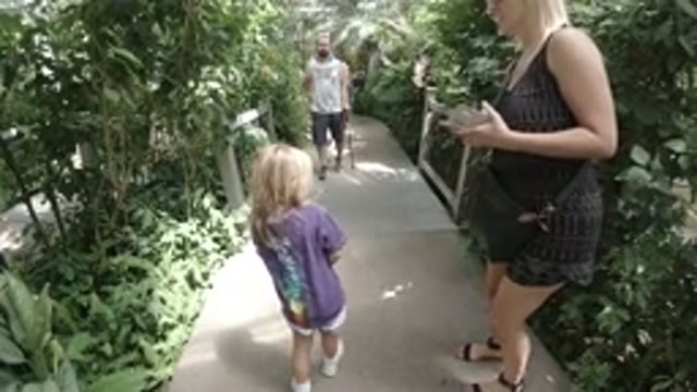 DENVER COLORADO-2019: A Blonde Girl in White Shorts Walking with a Woman