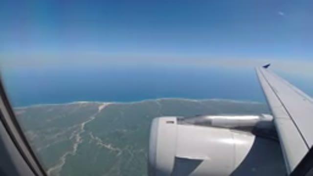 LOS CABOS MEXICO-2019: A View From An Airplane Window Of Clear Blue Water And Coastal Scenery