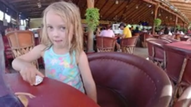 LOS CABOS MEXICO-2019: Shot Of A Child In A Restaurant Sitting And Playing At