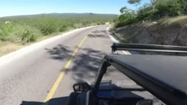 LOS CABOS MEXICO-2019: Car Driving Down Desert Road