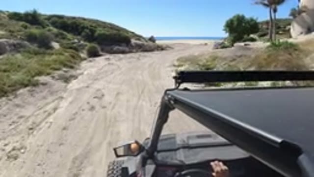 LOS CABOS MEXICO-2019: Jeep Running on Beach Road Near Mountain and Beach