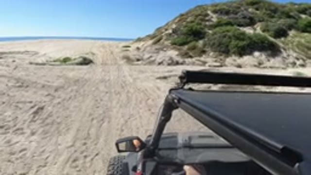 LOS CABOS MEXICO-2019: Jeep Driving Along Beach Road Near Ocean