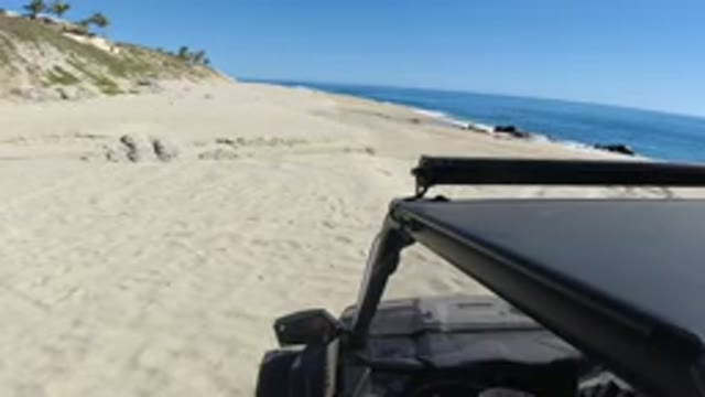 LOS CABOS MEXICO-2019: Camera Sitting On Top Of A Jeep On A Sandy Beach