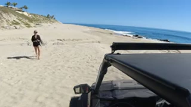 LOS CABOS MEXICO-2019: Woman Walking on Beach After Swimming in Ocean