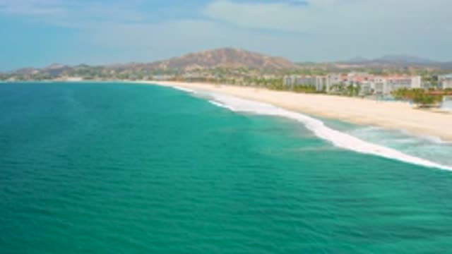 SAN JOSE DEL CABO MEXICO-2020: White Tall Building Blue Sea Water White Waves