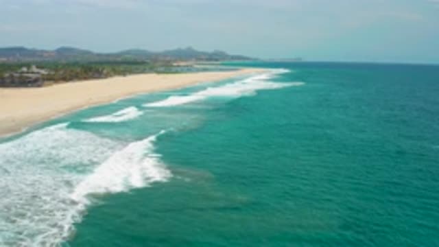 SAN JOSE DEL CABO MEXICO-2020: Rolling Waves Come In Along A Long Empty Sandy