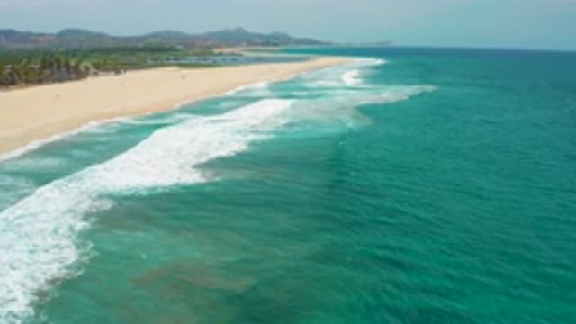 SAN JOSE DEL CABO MEXICO-2020: Clear Blue Ocean With Waves Crashing Into An Empty Beach