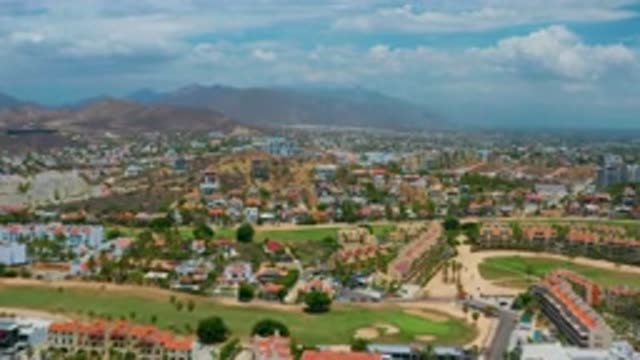 SAN JOSE DEL CABO MEXICO-2020: Aerial View of Green Roofs, Blue Sky, Clouds, and Mountains