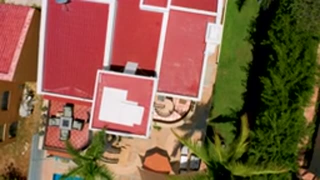 SAN JOSE DEL CABO MEXICO-2020: Aerial Footage Of A Camera Looking Down On A Red Roofed House