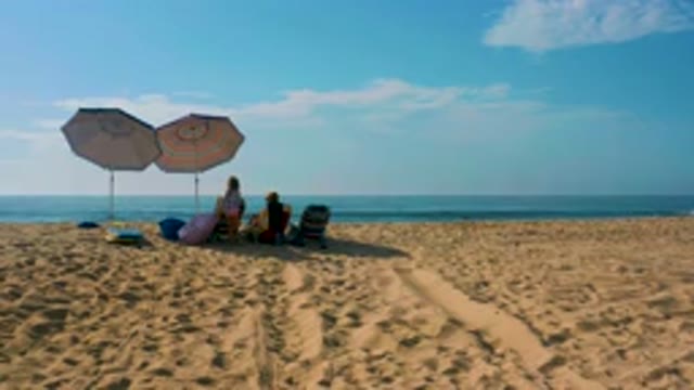 SHIPWRECKS BEACH BAJA CALIFORNIA SUR MEXICO-2020: People Relaxing Under Umbrellas On Sandy Beach