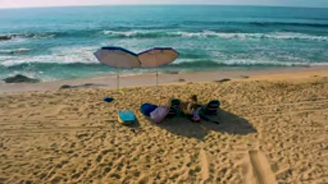 SHIPWRECKS BEACH BAJA CALIFORNIA SUR MEXICO-2020: Aerial View of Beachgoers Relaxing Under Umbrellas