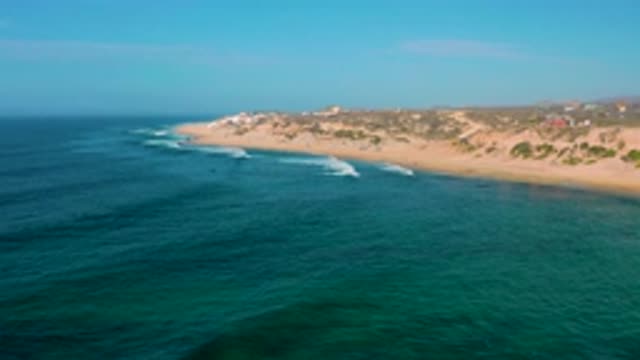 SHIPWRECKS BEACH BCS MEXICO-2020: Sandy Plant Filled Shore Sits Midst Deep Blue Waves