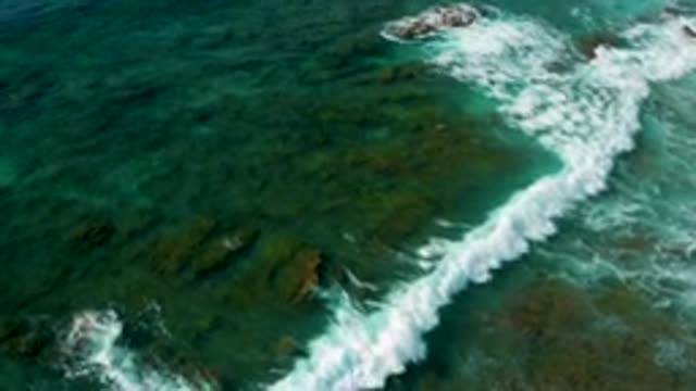 SHIPWRECKS BEACH BCS MEXICO-2020: Waves Pass Over A Green Shallow Bottom Toward