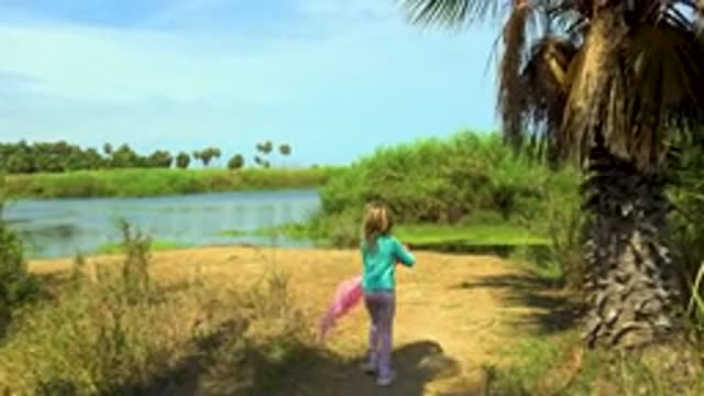 SAN JOSE DEL CABO MEXICO-2020: Little Girl Walking in Field Wearing Pink Clothes