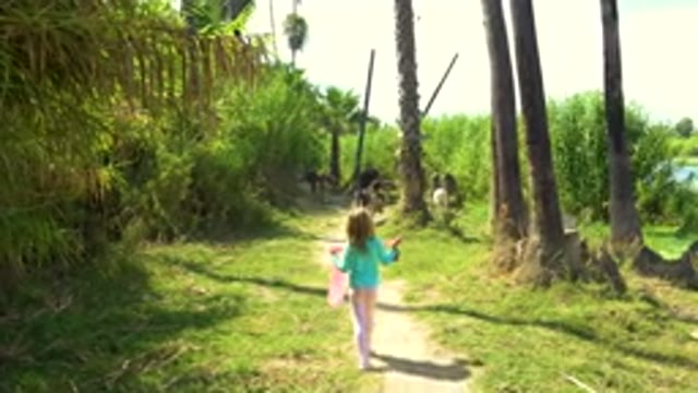 Little Girl Running Along Tropical Path