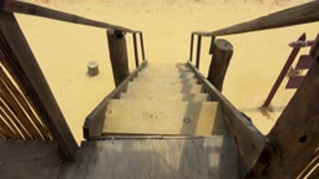 SAN JOSE DEL CABO MEXICO-2020: Child Descending Wooden Staircase Into Sand