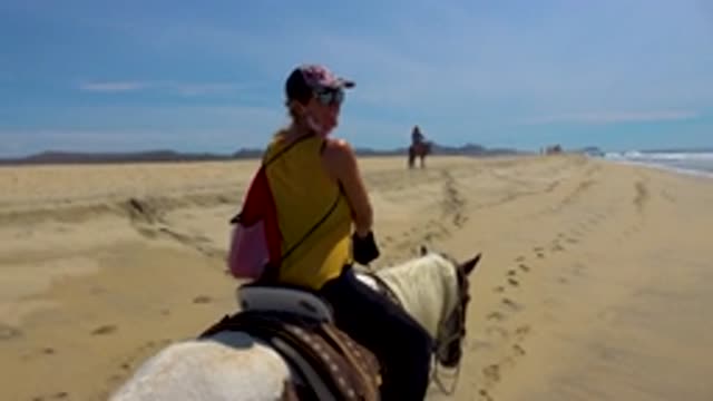 SAN JOSE DEL CABO MEXICO-2020: Two People Ride A Horse To The Sea