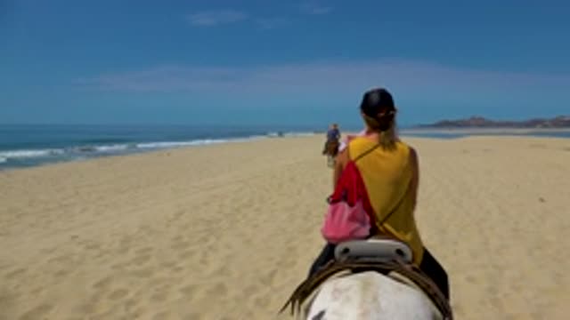 SAN JOSE DEL CABO MEXICO-2020: Lady Riding Horse With Short Hair Hanging A Red Bag