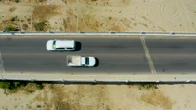 SAN JOSE DEL CABO MEXICO-2020: White Car And White Truck Passing On A Concrete Road