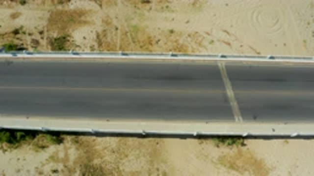 SAN JOSE DEL CABO MEXICO-2020: White Car Traveling Along Desert Highway At Speed