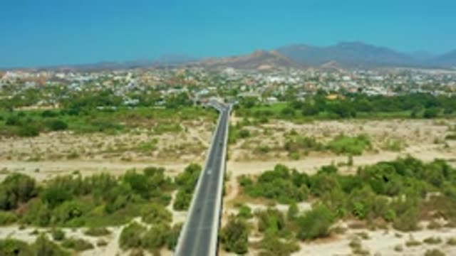 SAN JOSE DEL CABO MEXICO-2020: A Concrete Road Car Running Fastball And Trees