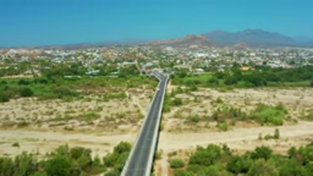 SAN JOSE DEL CABO MEXICO-2020: Long Thin Highway Stretches Through Trees And Mountains