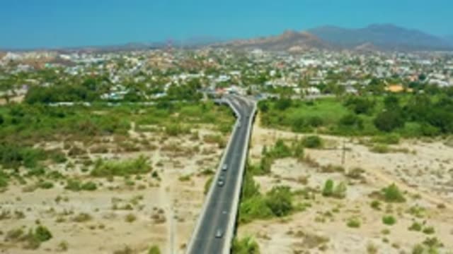 SAN JOSE DEL CABO MEXICO-2020: Long Concrete Road Car Running Fastball Green
