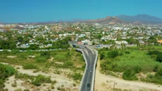 SAN JOSE DEL CABO MEXICO-2020: Road With Cars Approaching City With Mountains