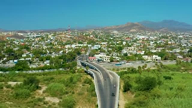 SAN JOSE DEL CABO MEXICO-2020: Cars Driving Into Town Along Highway Surrounded