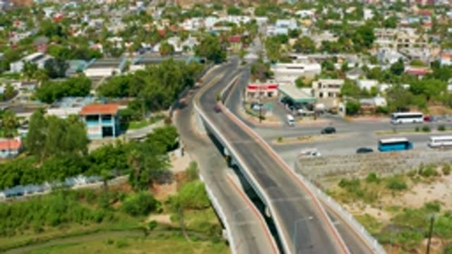 SAN JOSE DEL CABO MEXICO-2020: Vehicles Driving Over And Under Bridge In The