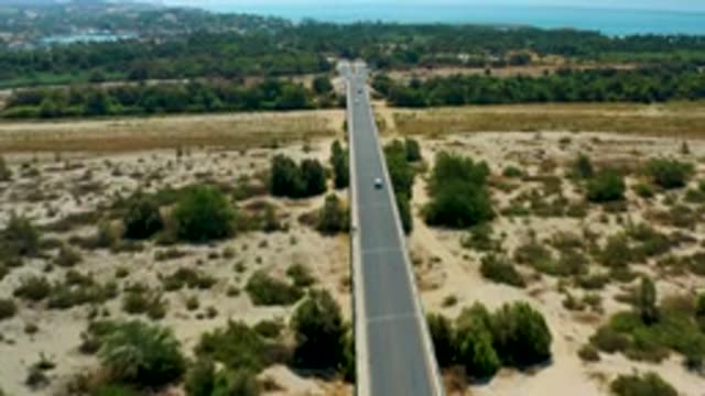 SAN JOSE DEL CABO MEXICO-2020: Car Running Fastball Green Bushes And Trees Two