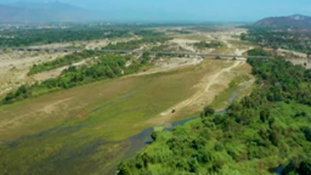 SAN JOSE DEL CABO MEXICO-2020: Concrete Bridge Green Trees Muddy Roads Mountains